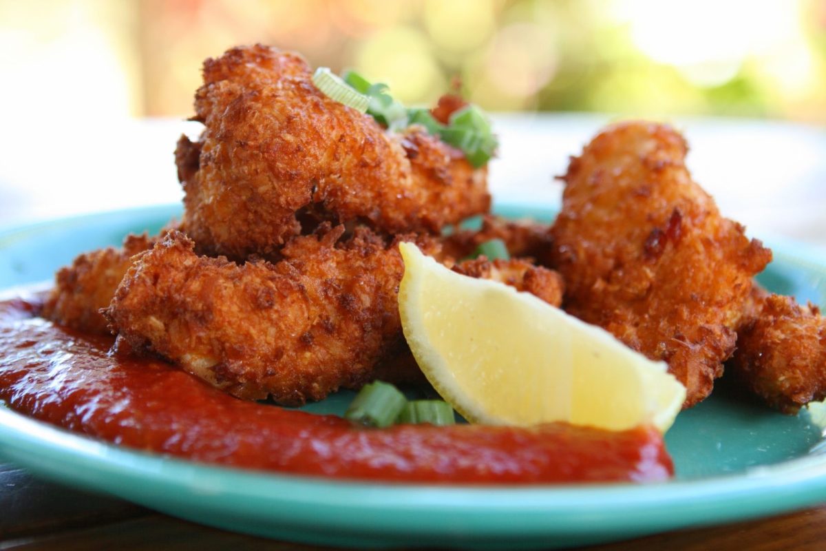 plate of conch fritters with lemon and sauce